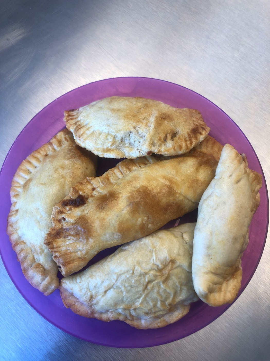 A plate of golden hand-made empanadas fresh from the oven