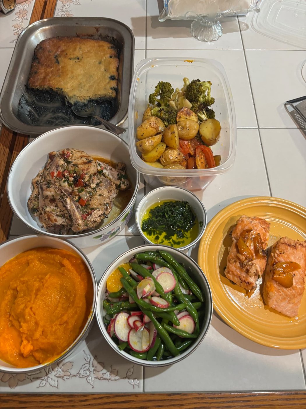 A full home-cooked spread of chicken, salmon, roasted vegetables and puree